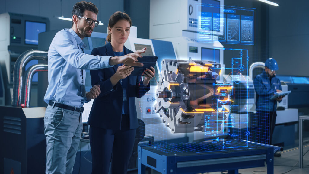 Factory Office Facility: Chief Engineer Holds Tablet Computer, Shows Augmented Reality Model of an Electric Generator to a Female Project Manager. Industry 4.0 Research and Development Center.