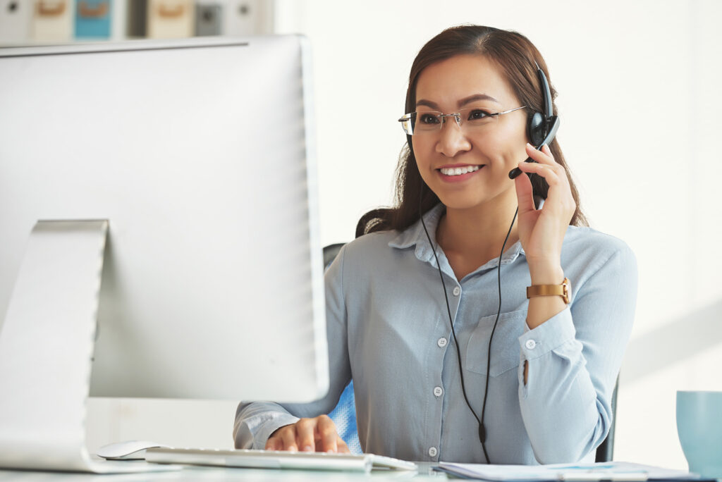 Smiling business lady working in call center