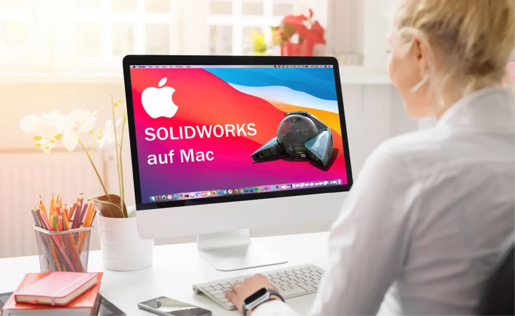 Frau sitzt vor einem Mac-Rechner mit SOLIDWORKS.